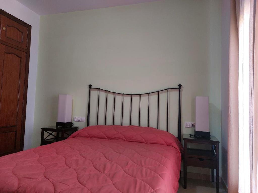 Łóżko lub łóżka w pokoju w obiekcie Vivienda Turística Ronda del Carmen