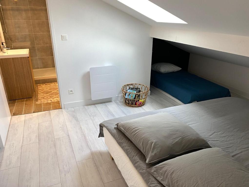 a bedroom with a bed and a bathroom with a shower at L&#39;ETERNEL in Longeville-lès-Metz