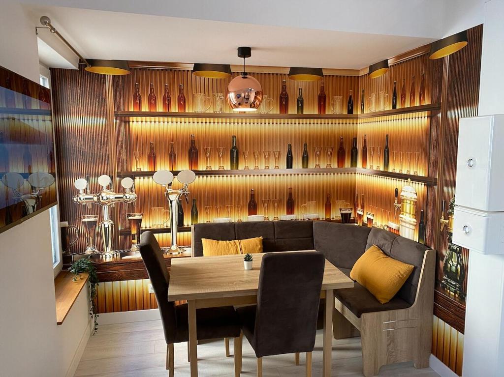 a dining room with a wooden wall with wine bottles at L&#39;ETERNEL in Longeville-lès-Metz