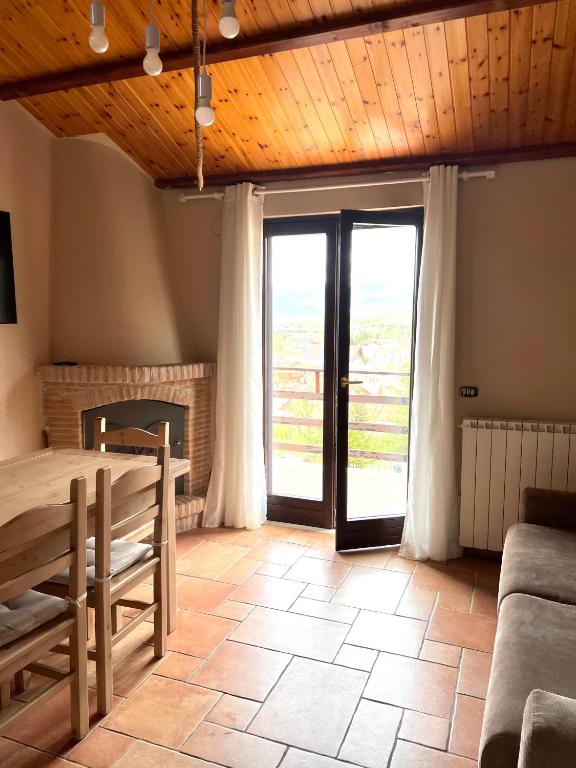 a living room with a table and a fireplace at Ai house boutique in Castel di Sangro