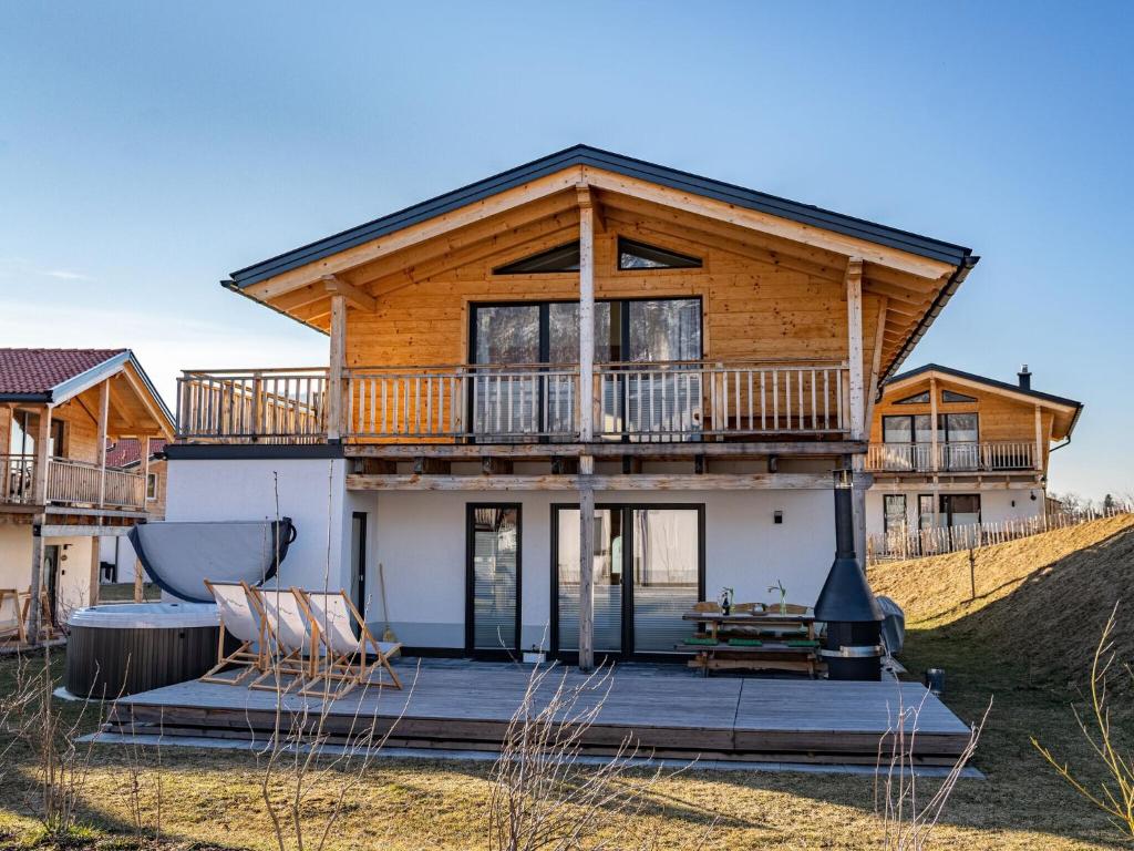 a house on a hill with a deck at Chalet Charivari Inzell, Inzell in Inzell
