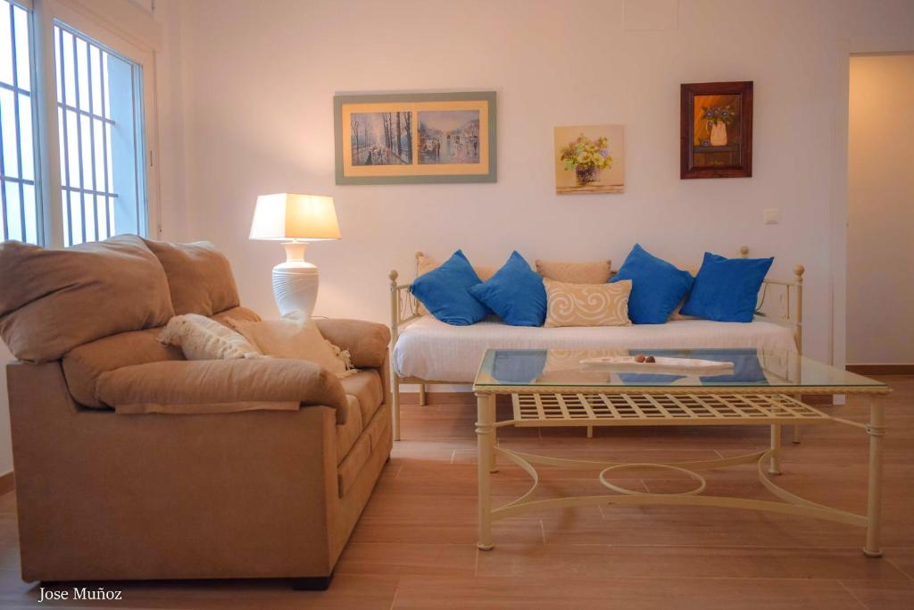 a living room with a couch and a coffee table at 2 bedrooms appartement with wifi at Penaflor in Peñaflor
