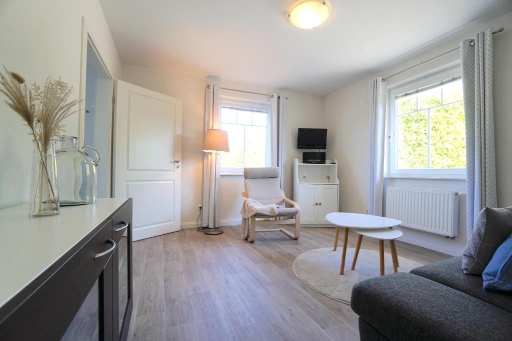 a living room with a couch and a table at Ferienwohnung Schleistübchen in Fahrdorf