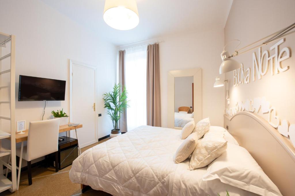 Postel nebo postele na pokoji v ubytování Hotel Tigullio