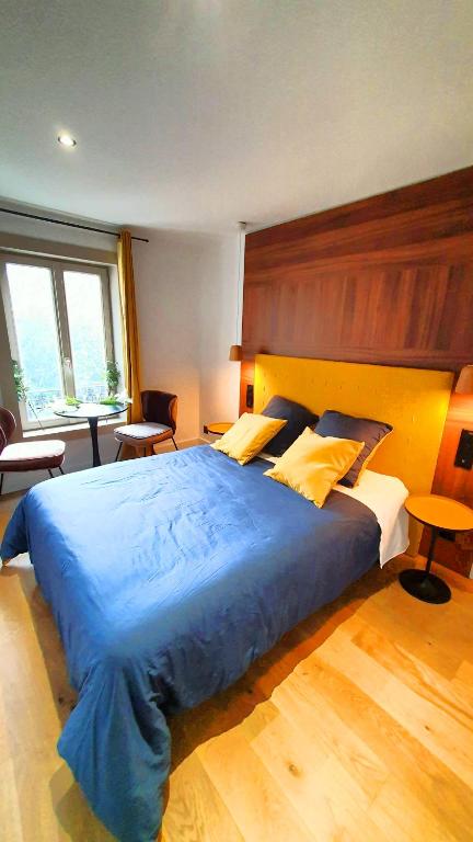a bedroom with a large bed with a blue blanket at Suite Saint Lô Rouen (Centre Historique) in Rouen