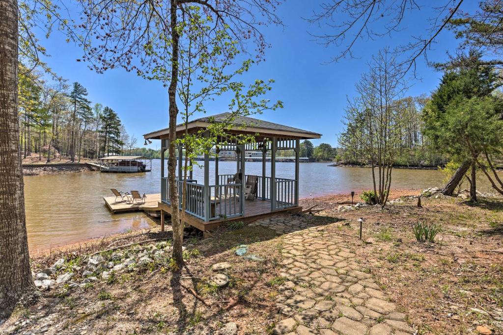 a gazebo on the side of a river at Pet-Friendly Wedowee Home with Hot Tub and Dock! in Wedowee