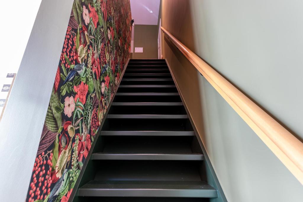 a staircase in a building with a rug on the wall at Apollonia in Aalter