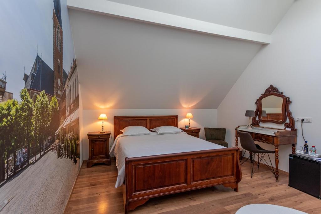 a bedroom with a large bed and a piano at Apollonia in Aalter