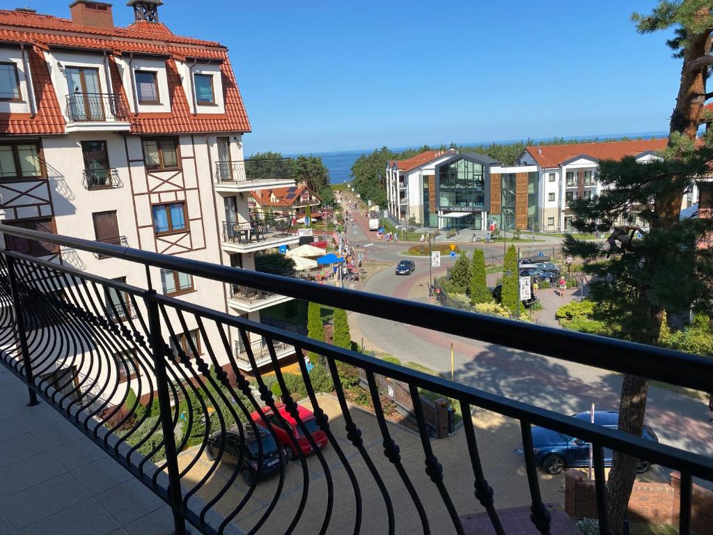 balcón con vistas a la calle y a los edificios en Apartament z widokiem na morze, en Krynica Morska