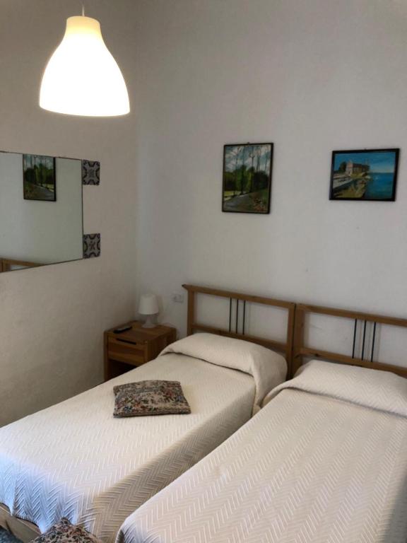 A bed or beds in a room at Rocca Sul Mare Hotel