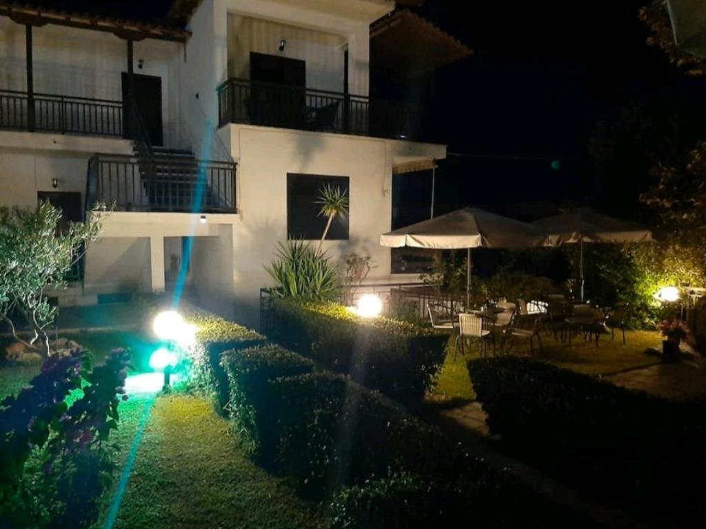 a house at night with lights in the yard at Despoina House in Psakoudia