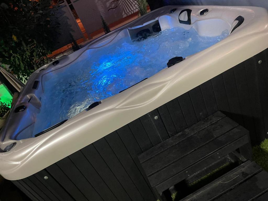 a bath tub with blue water in it at נופי ארבל in Livnim