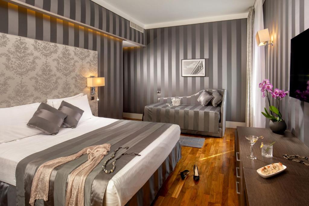 A bed or beds in a room at Monti Palace Hotel