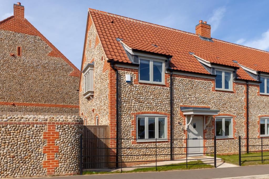 a brick house with a red roof at Choseley Cottage - Norfolk Cottage Agency in Docking