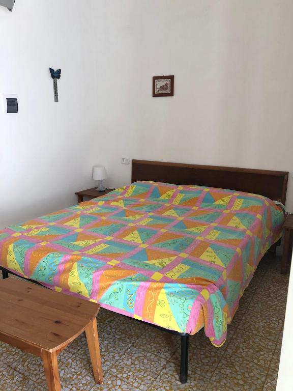 A bed or beds in a room at Rocca Sul Mare Hotel