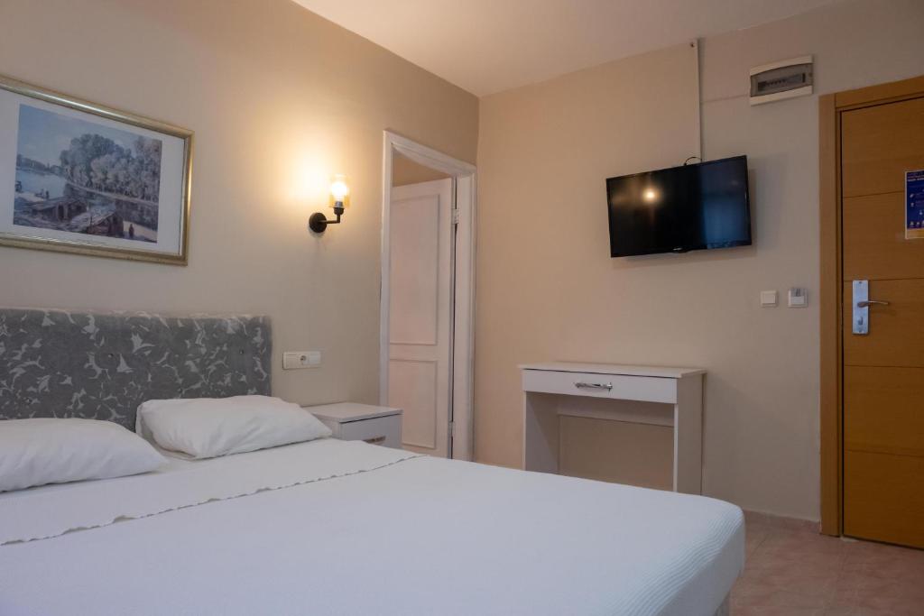 Postel nebo postele na pokoji v ubytování Arden Hotel