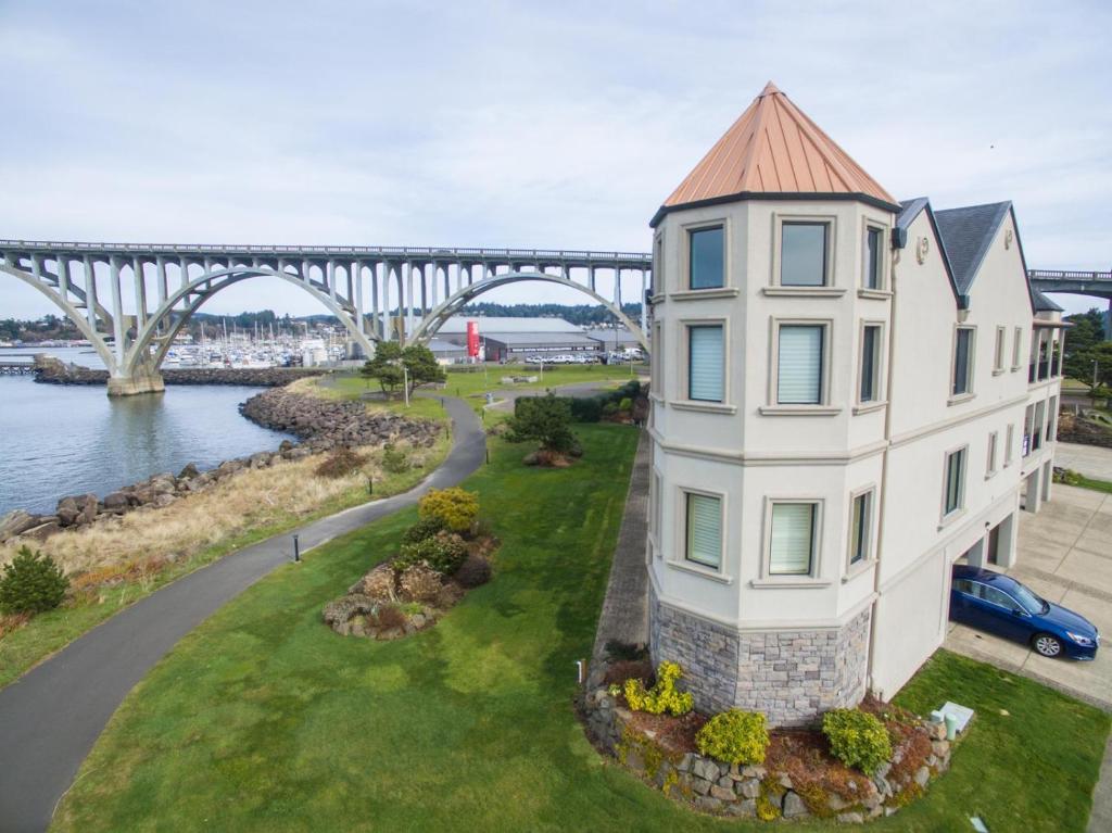 an aerial view of a white building with a bridge in the background at Windward at the Regatta in Newport