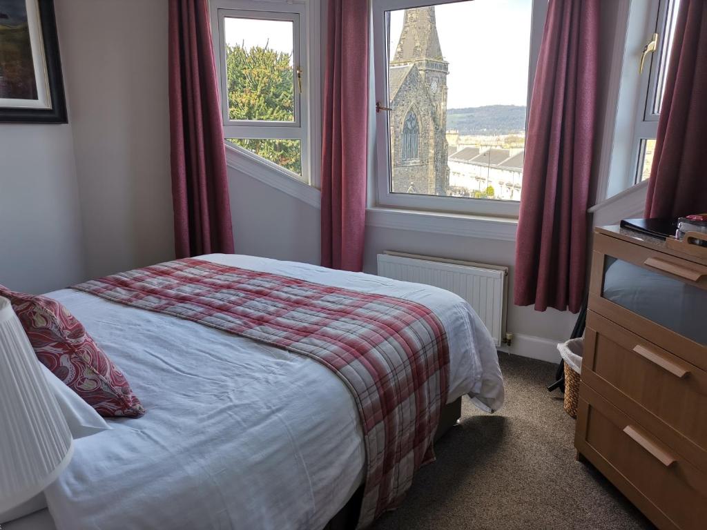 Säng eller sängar i ett rum på Munro Guest House