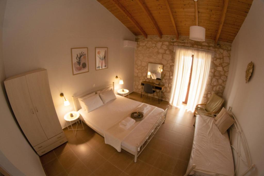 a living room with a bed and a window at Noemie Studios in Athani