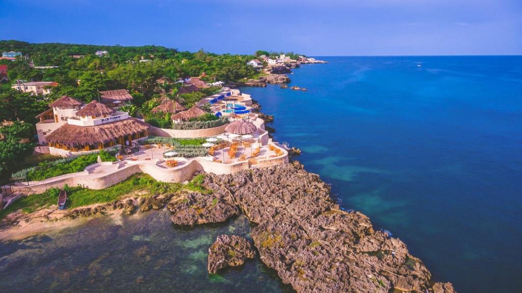 an aerial view of a resort on the edge of the ocean at Ocean Cliff Hotel Negril Limited in Negril