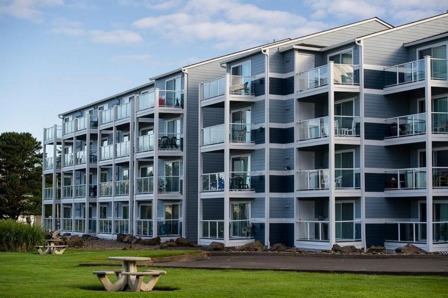 an apartment building with a park in front of it at Waters Edge 312 in Lincoln City