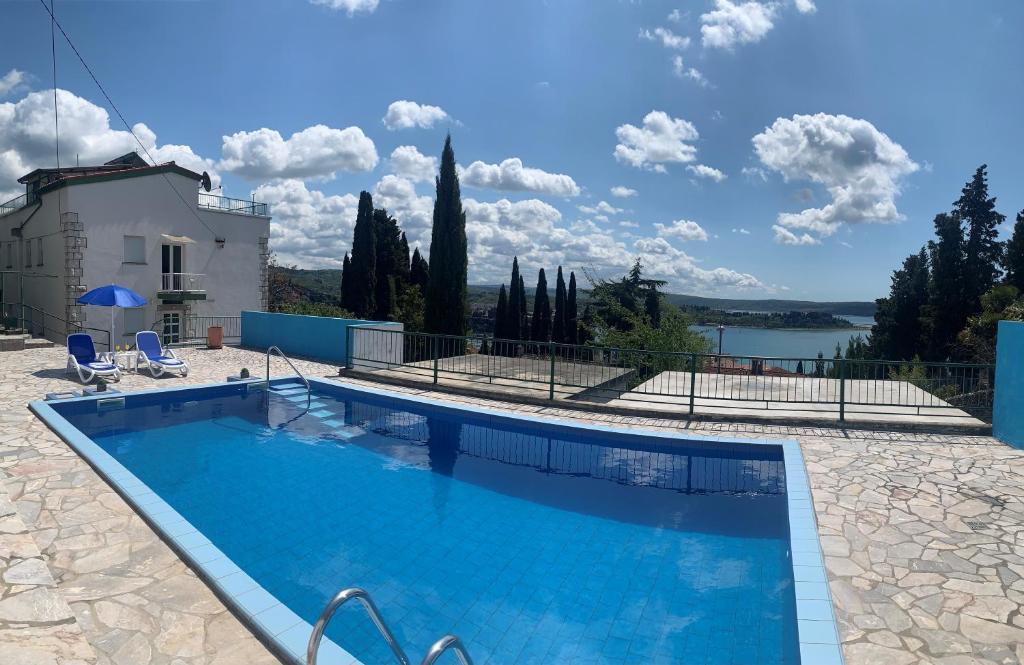 a swimming pool in front of a house at Apartmaji Amitis in Portorož