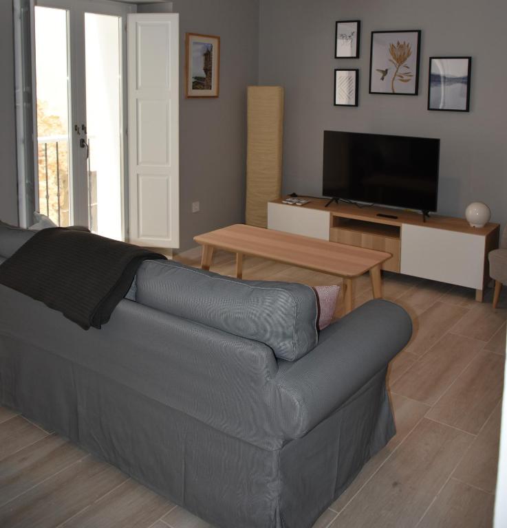 a living room with a couch and a table at Sweet Arco Rosa Zona Centro in Cádiz