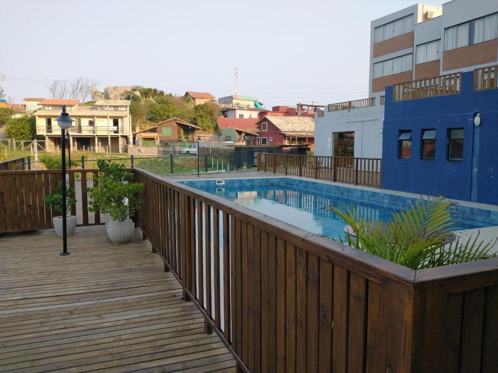 a deck with a swimming pool on a building at Residence Farol - Loft 206 in Laguna