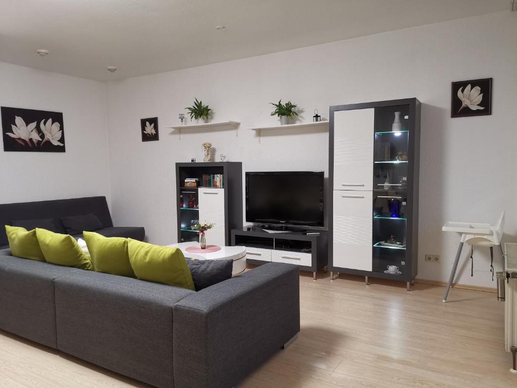 uma sala de estar com um sofá e uma televisão de ecrã plano em Ferienhaus Zoe 120 m2 em Solingen