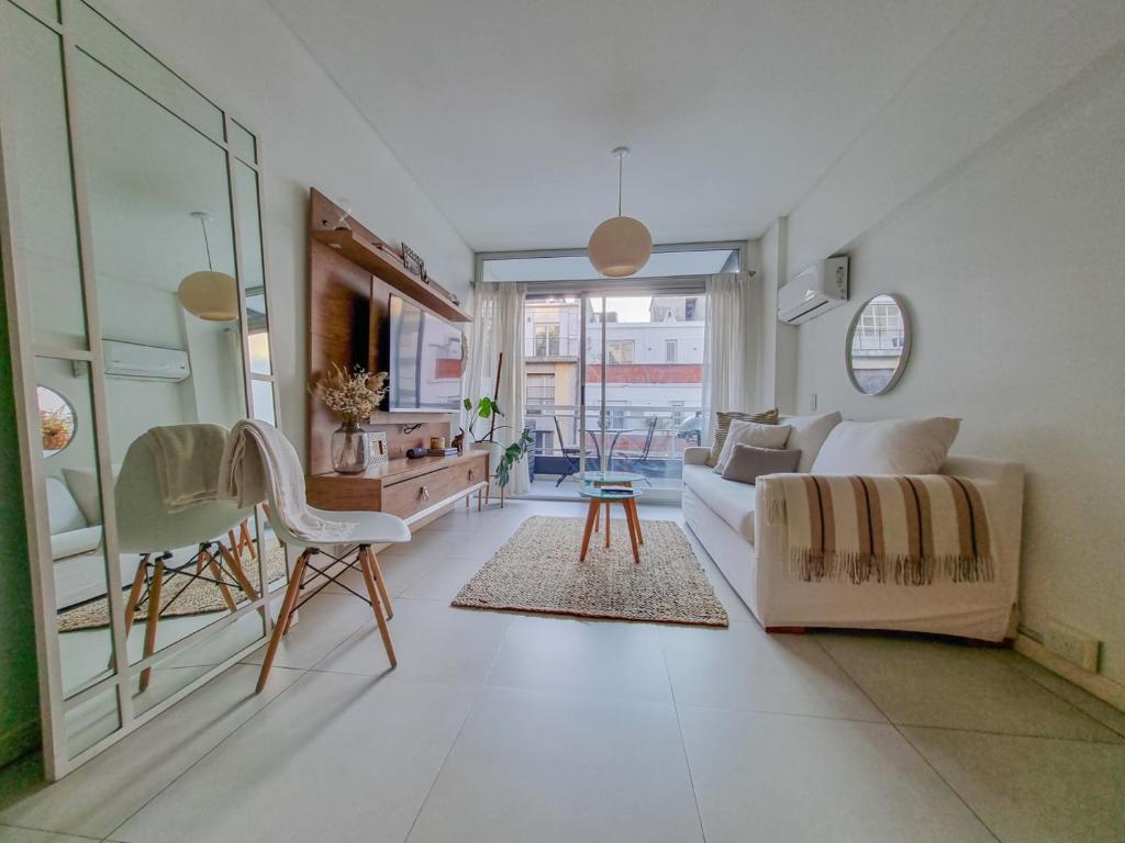 a living room with a couch and a table at Departamento en Palermo Chico in Buenos Aires