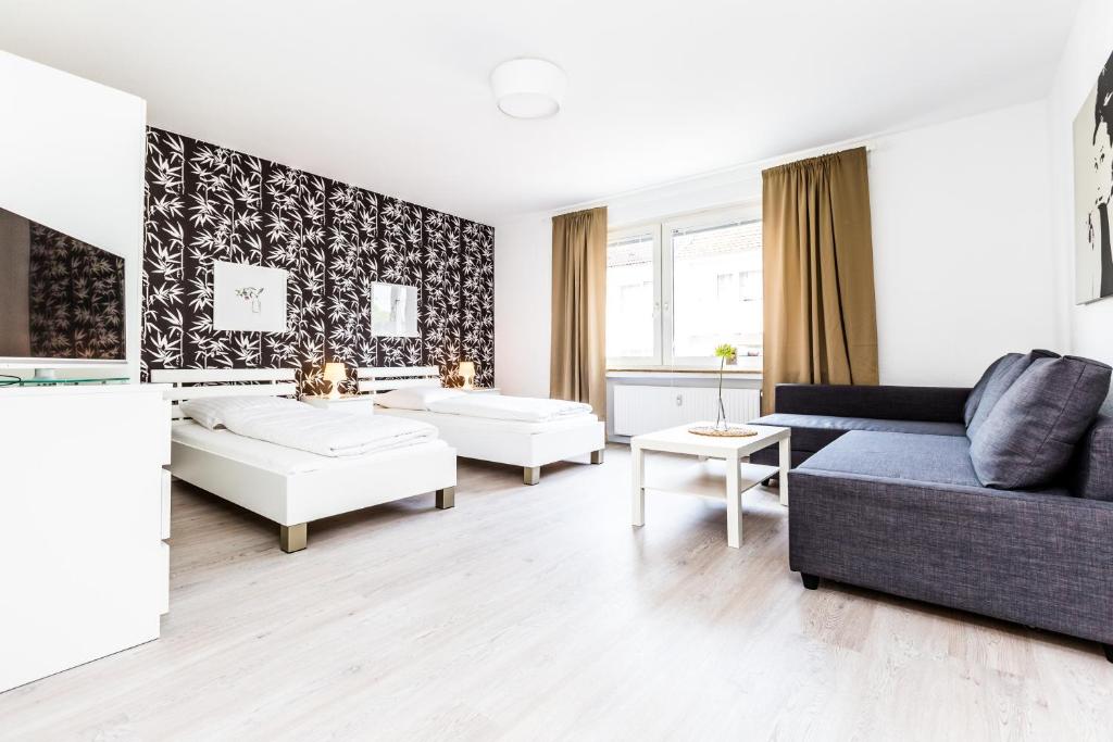 a living room with a couch and a table at Cityfair Apartments Köln in Cologne