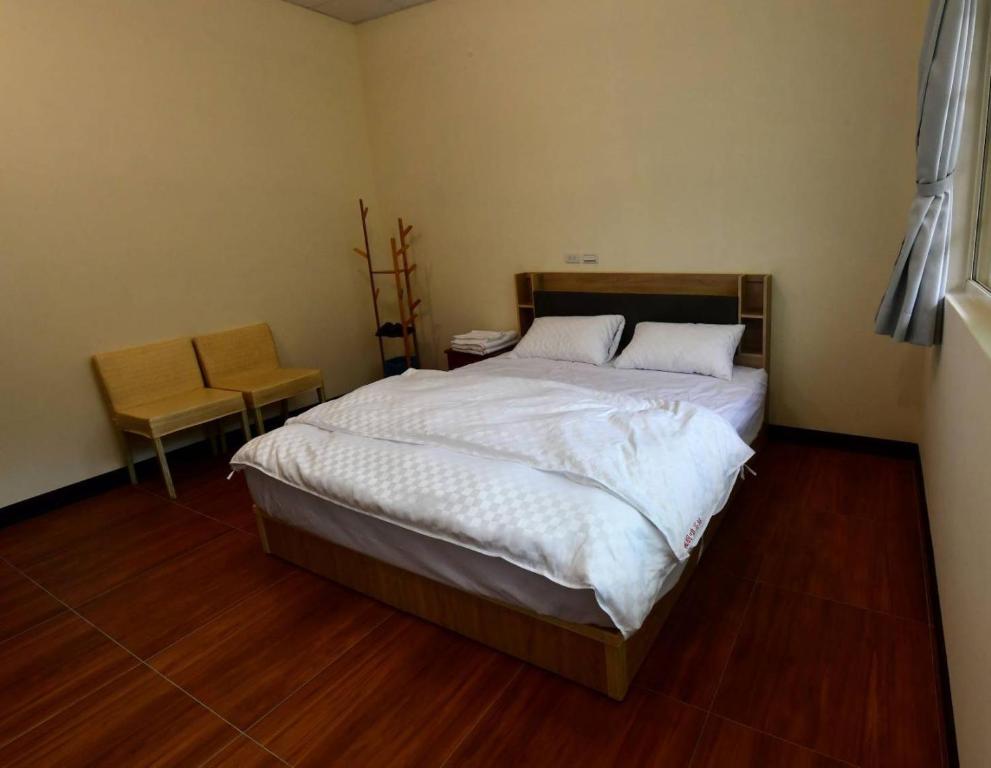 Postel nebo postele na pokoji v ubytování Hongpeng Coffee Station Homestay