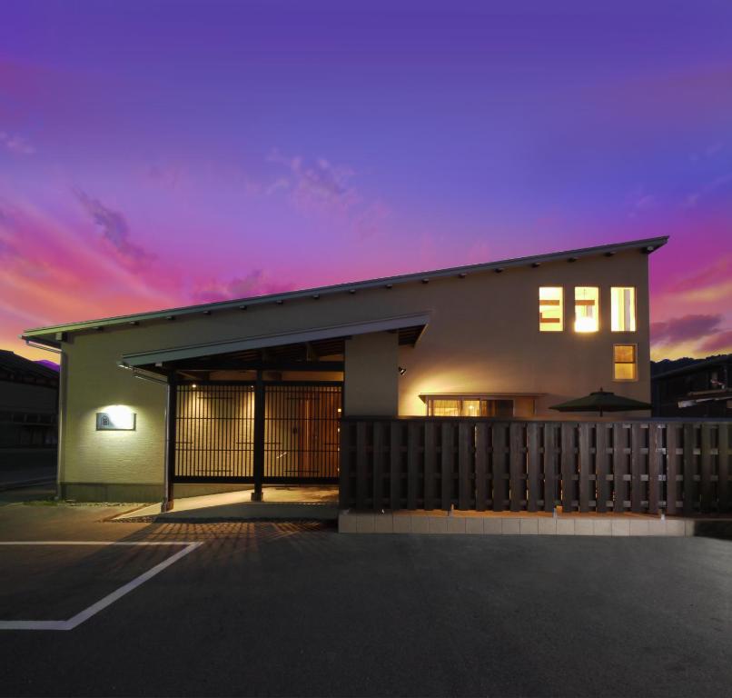 a building with a sunset in the background at villa-rizo古川 in Hida