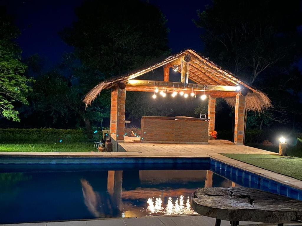 a pavilion with a swimming pool at night at Don Patron hotel&eventos in Villarrica