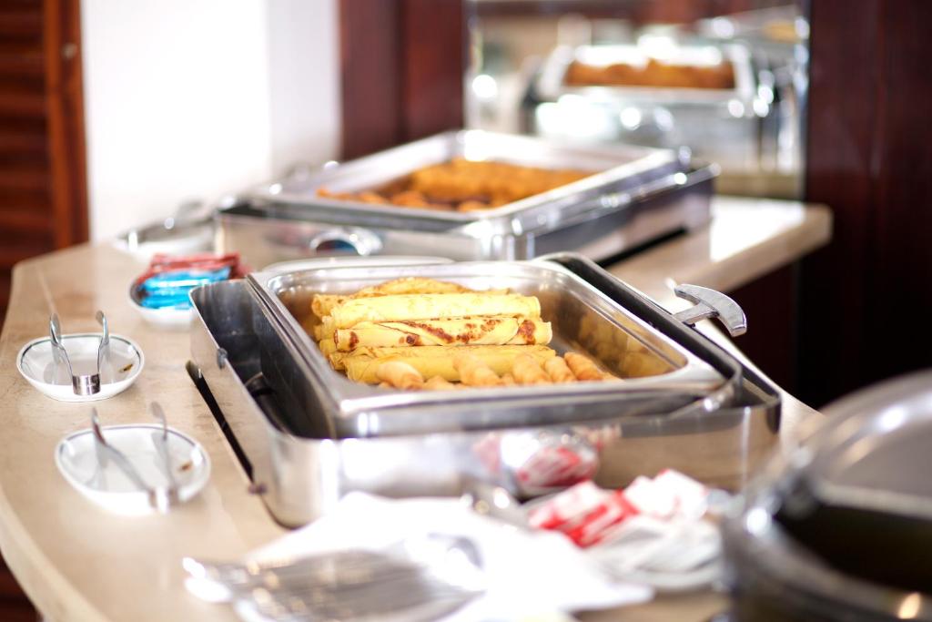 a buffet with two trays of food on a counter at Mosaic Hotel Old City -Special Category in Istanbul