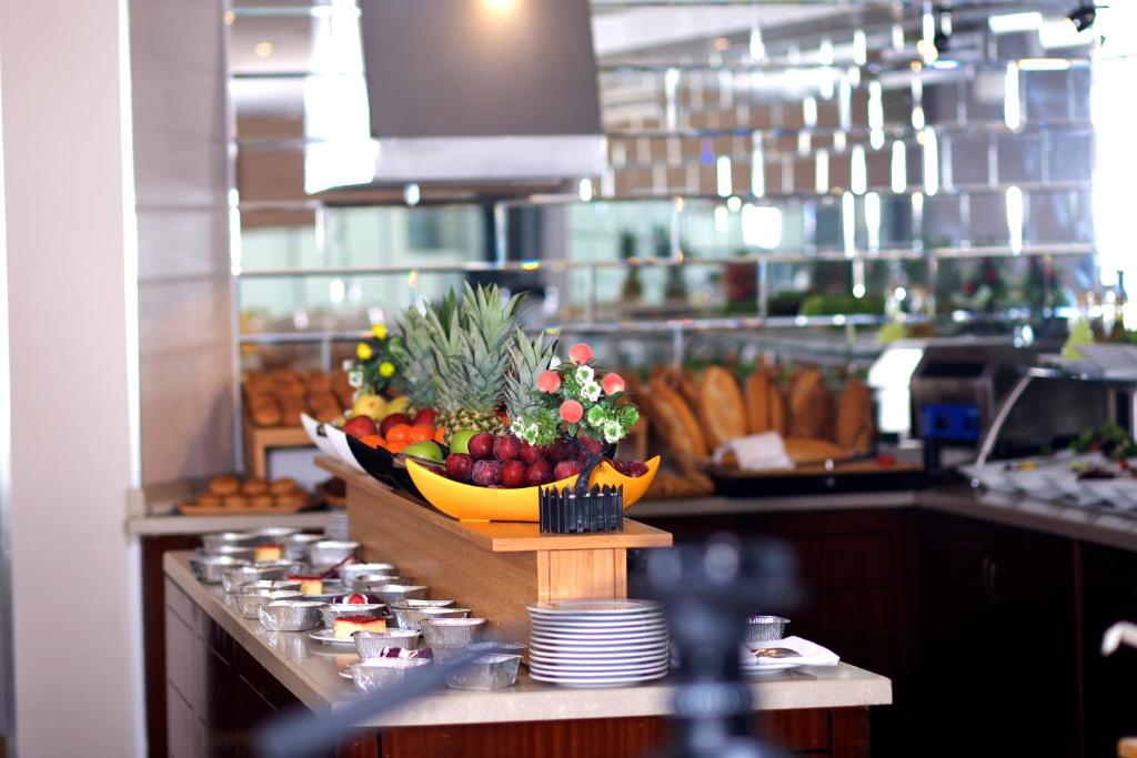 a buffet line with a bowl of fruit on a counter at Mosaic Hotel Old City -Special Category in Istanbul