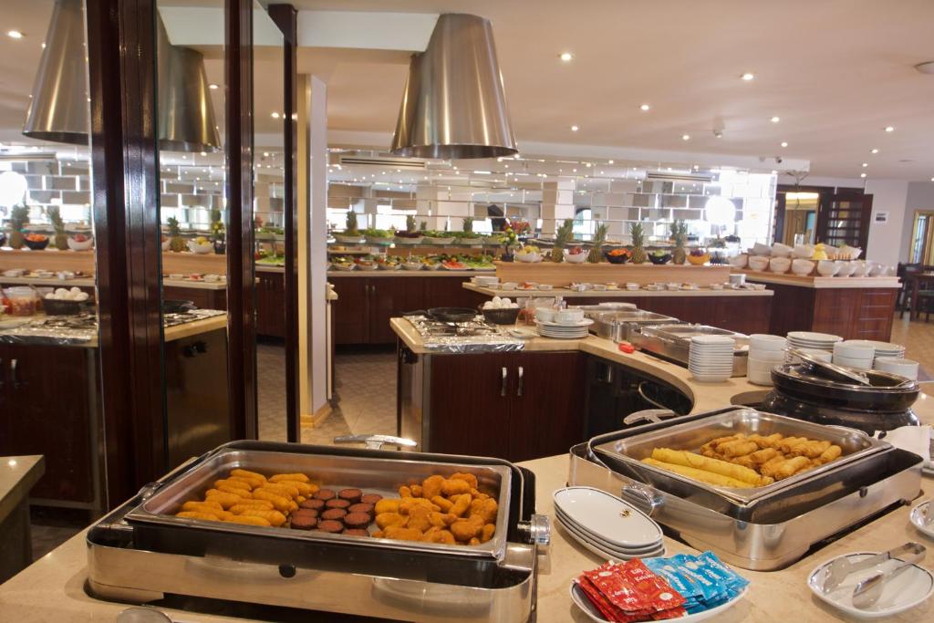 a restaurant kitchen with food on a counter at Mosaic Hotel Old City -Special Category in Istanbul
