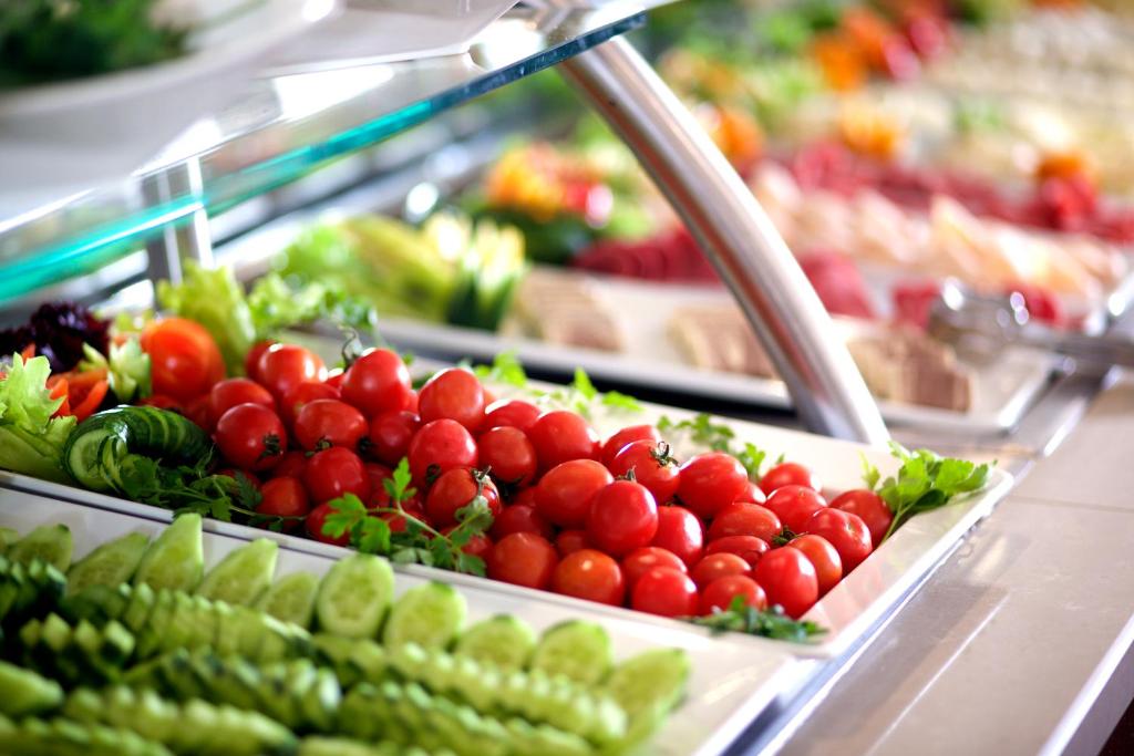 a display of tomatoes and other vegetables in a grocery store at Mosaic Hotel Old City -Special Category in Istanbul