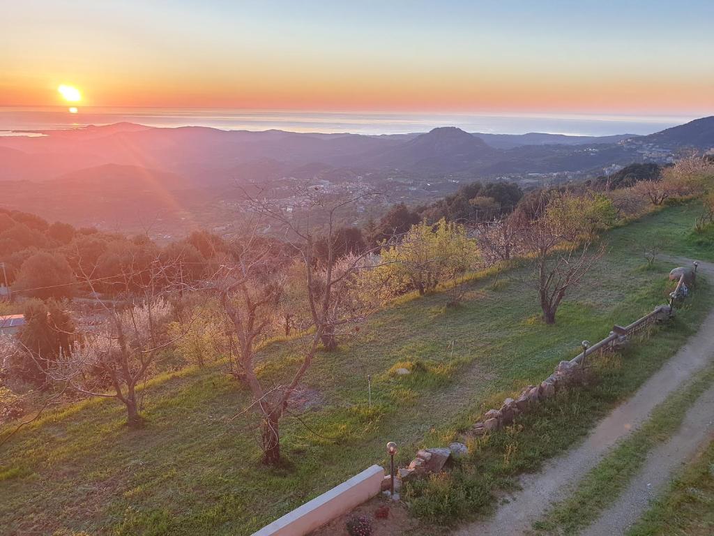 a sunset on a hill with a dirt road at Oasi del benessere in Ilbono