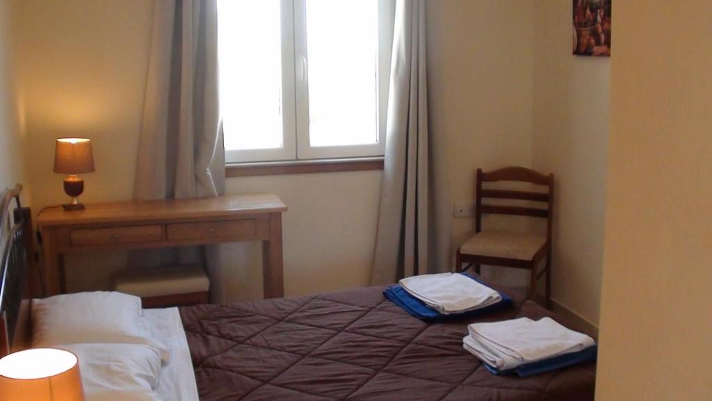a bedroom with a bed and a desk and a window at Pomos Harbourbiew Villa in Pomos