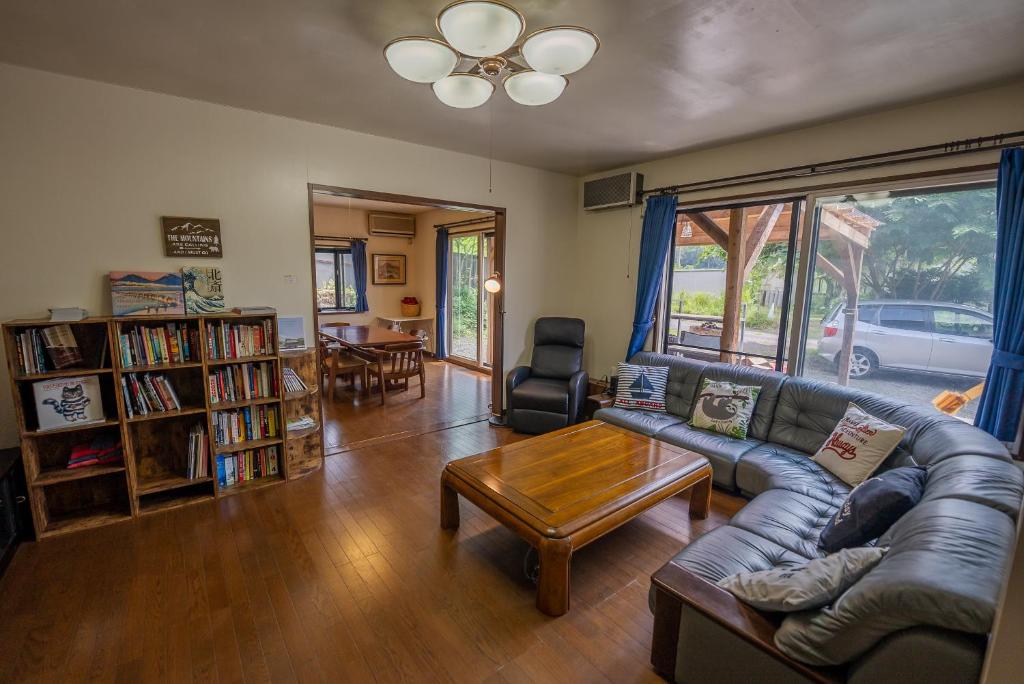 a living room with a couch and a table at Five Peaks Jigokudani in Shiga Kogen