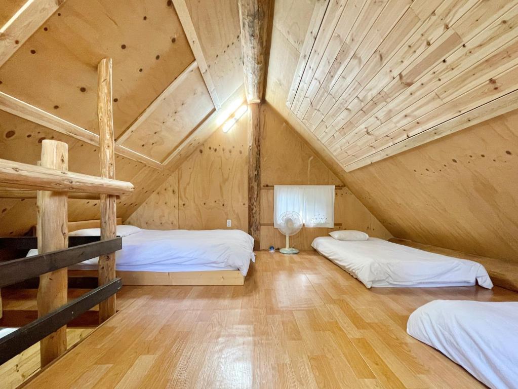 Postel nebo postele na pokoji v ubytování Log Park Dochidol Ranch