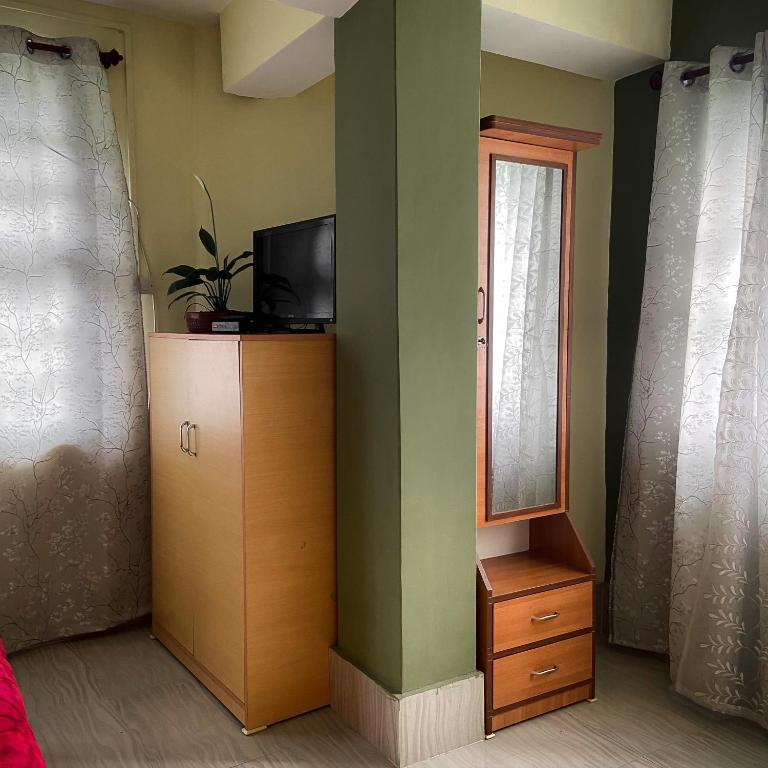 TV a/nebo společenská místnost v ubytování Ashraya Boutique Homestay