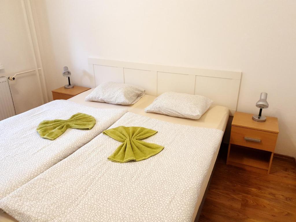 ein Schlafzimmer mit zwei Betten mit gelben Bogen darauf in der Unterkunft Apartmán BYSTRICA in Banská Bystrica