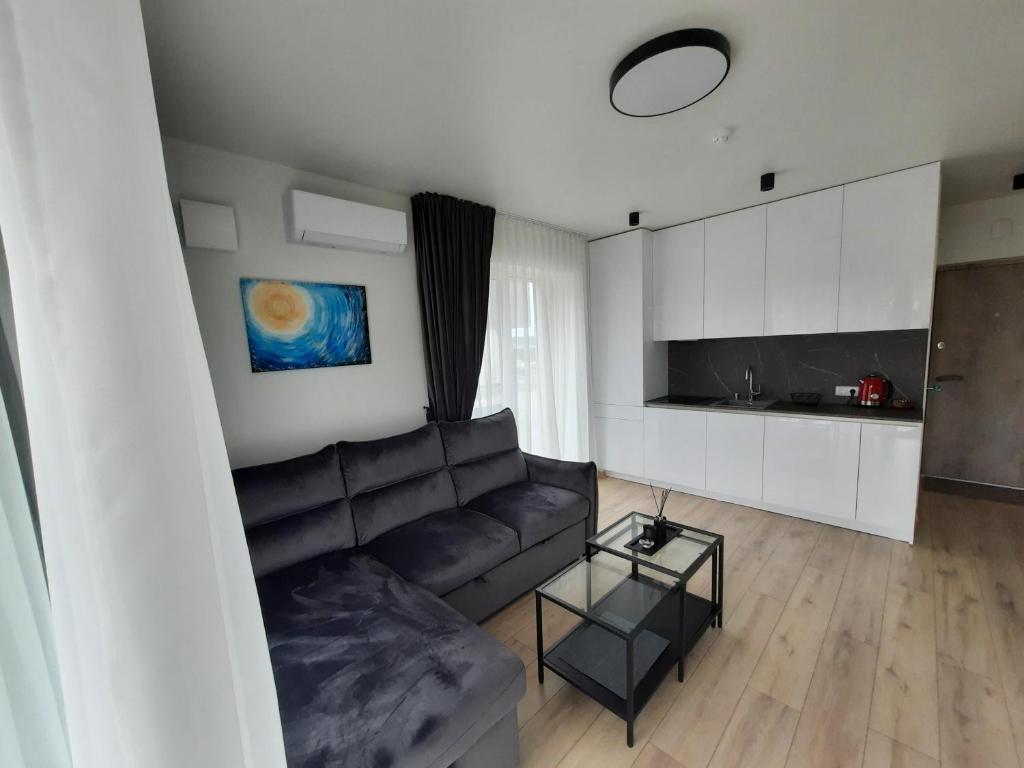 a living room with a couch and a table at SUN HOME in Palanga