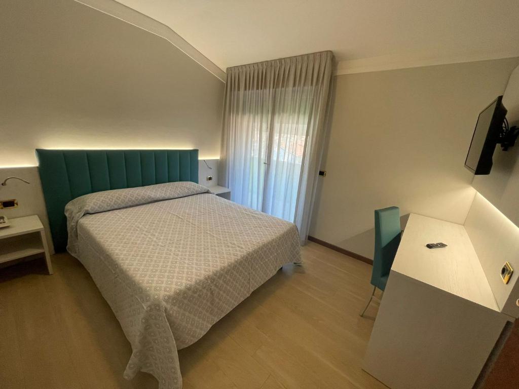 Postel nebo postele na pokoji v ubytování Hotel Corallo
