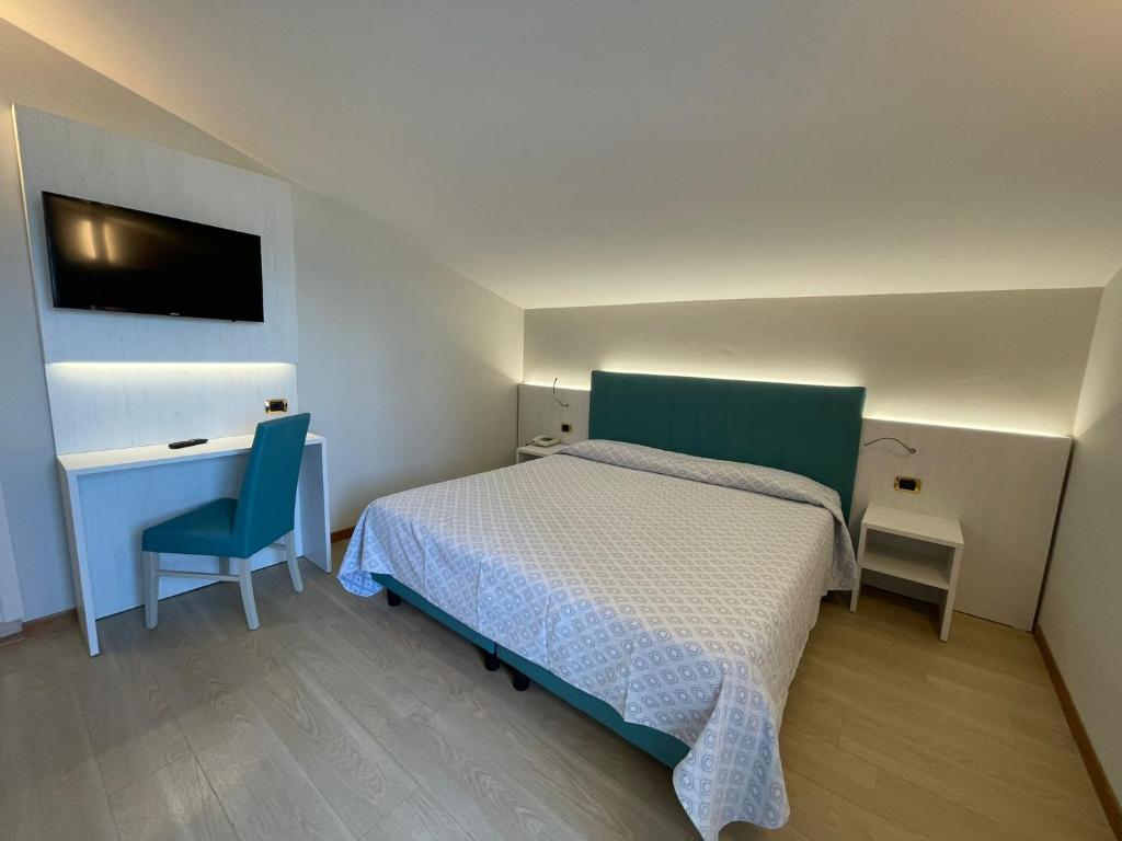 Postel nebo postele na pokoji v ubytování Hotel Corallo