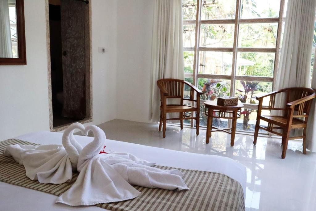 Postel nebo postele na pokoji v ubytování Aventus Resort Ubud