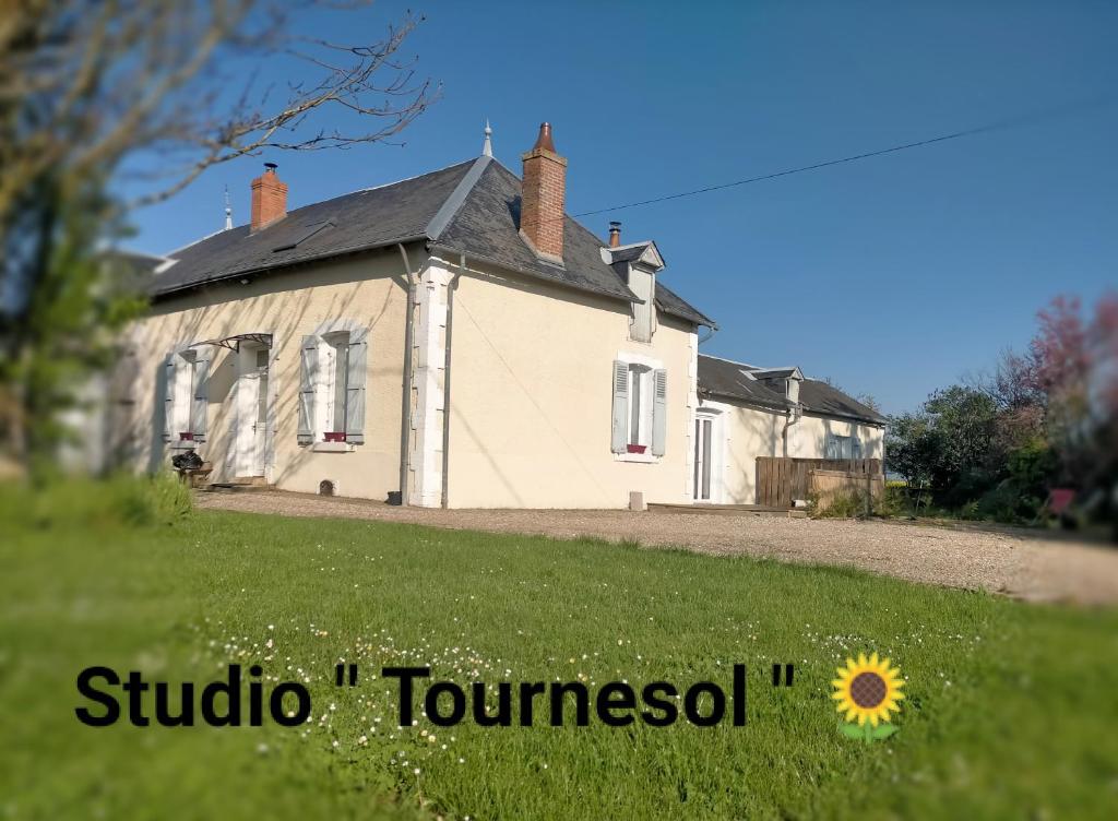 an old house with a sunflower in front of it at studio " tournesol " au coeur du Berry in Les Bordes