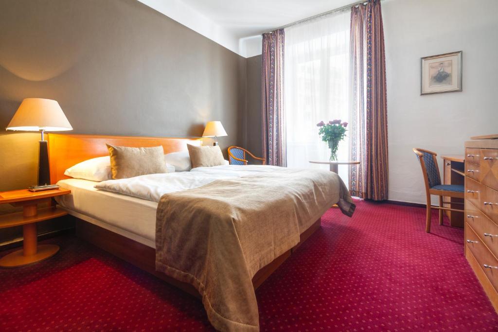 Postel nebo postele na pokoji v ubytování Hotel Harmony